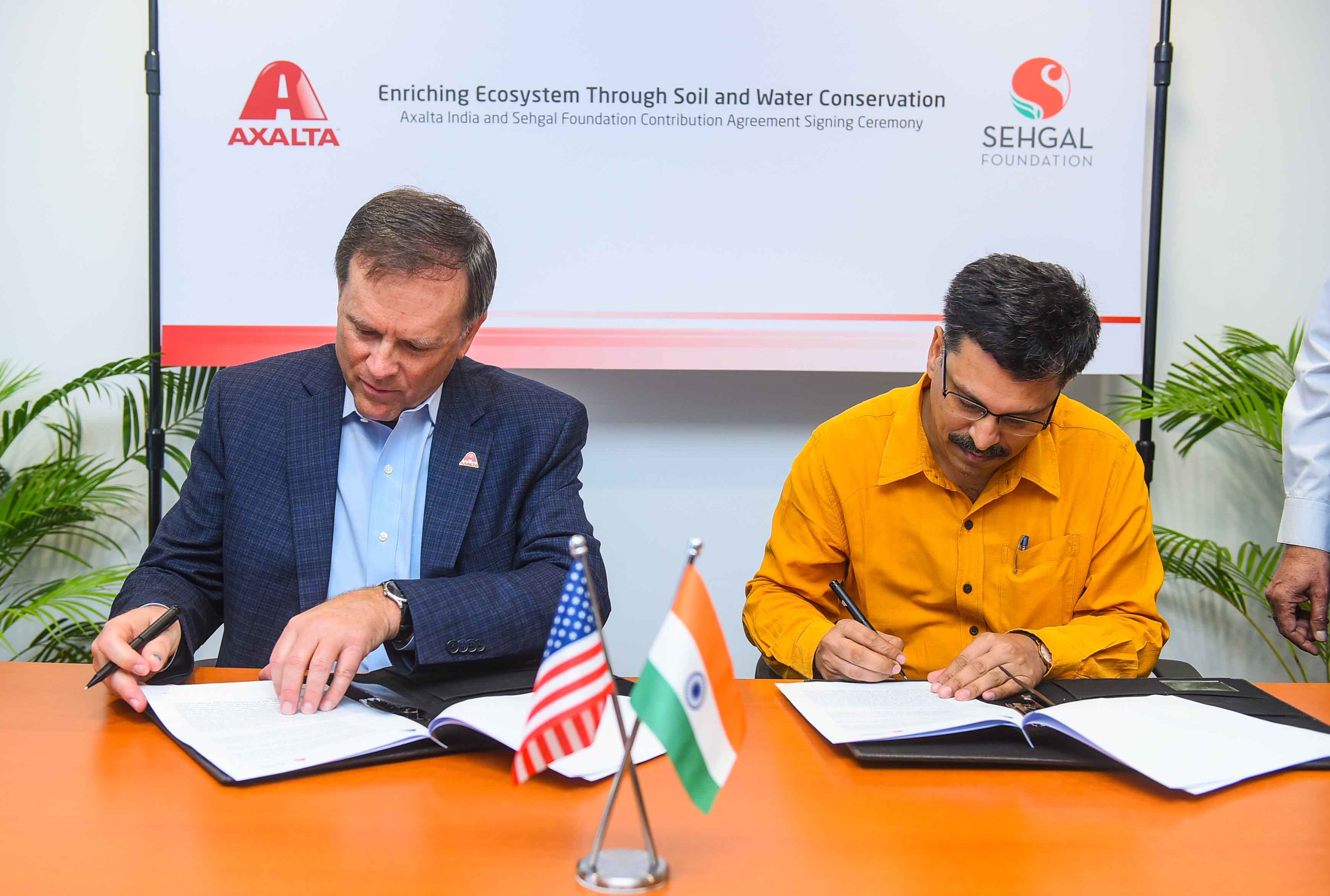 Axalta Chairman and CEO Charlie Shaver signs agreement with Seghal CEO Mr. Ajay Pandey